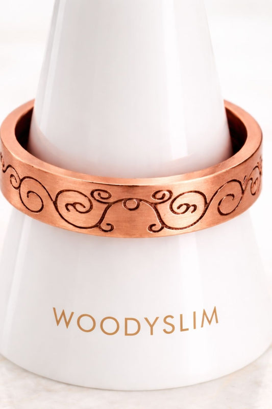 Bague en cuivre gravée motifs arabesques présentée sur un support blanc, largeur de l’anneau et détails visibles, bijou WoodySlim